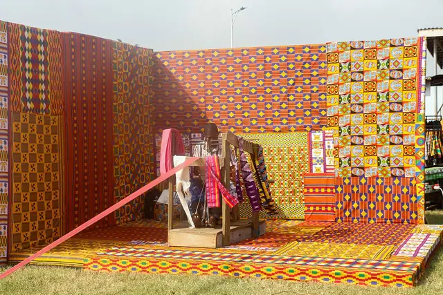 A Ghanaian craft maker weaving kente