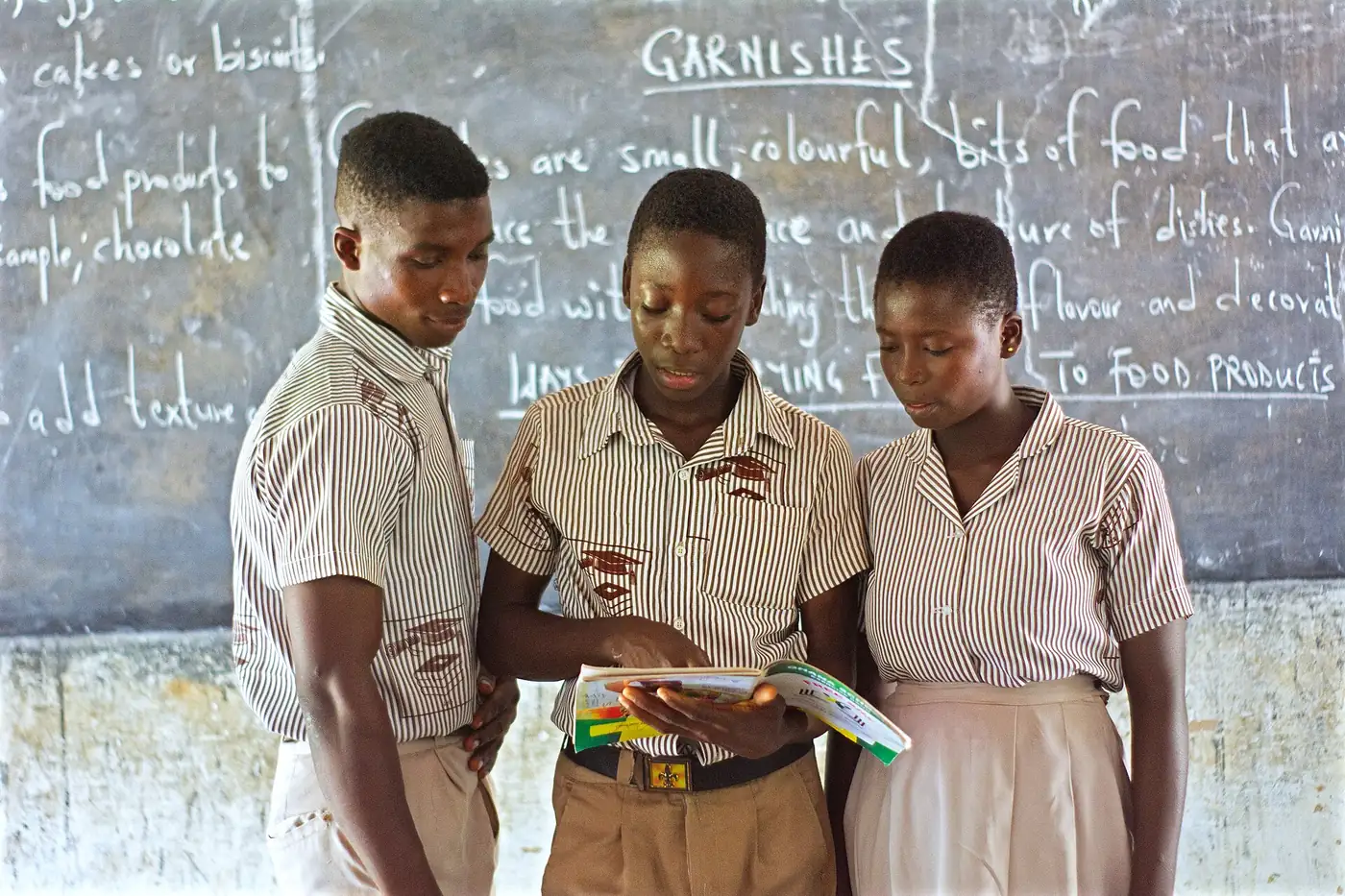 Students reading in a classroom in Ghana